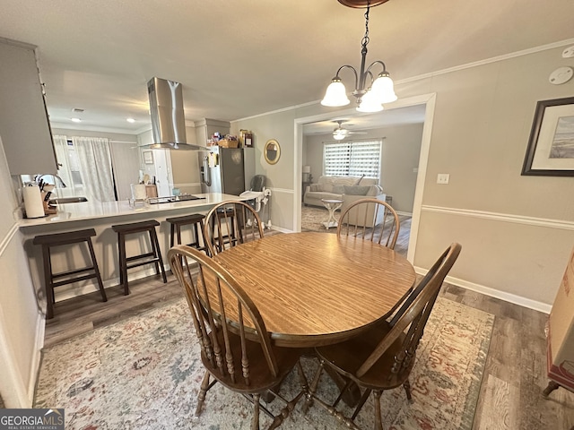 1815 Oak Spring St, Statham, GA 30666 - dining area featuring wood finished floors, a chandelier, crown molding, baseboards, and ceiling fan