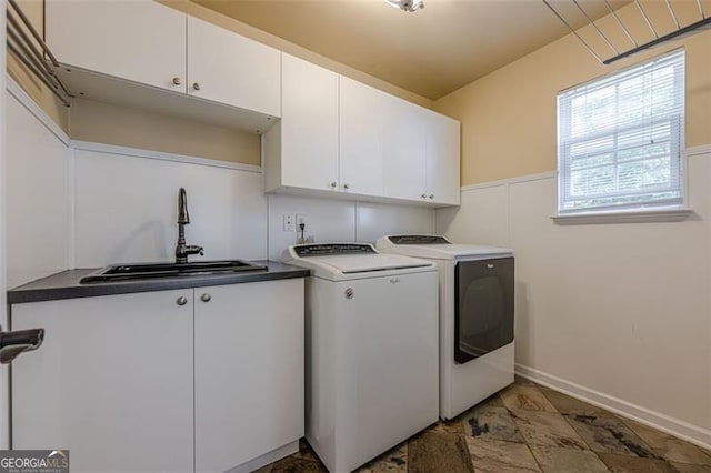 2304 Mitford Ct, Dacula, GA 30019 - laundry area featuring cabinet space, separate washer and dryer, and baseboards