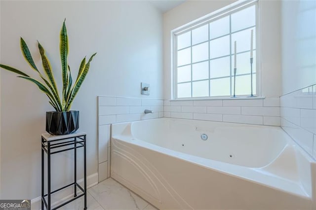 2304 Mitford Ct, Dacula, GA 30019 - bathroom with a tub with jets and marble finish flooring