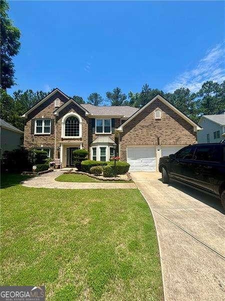 7625 Cedar Grove Ct, Fairburn, GA 30213 - traditional-style house with driveway, a front yard, and a garage