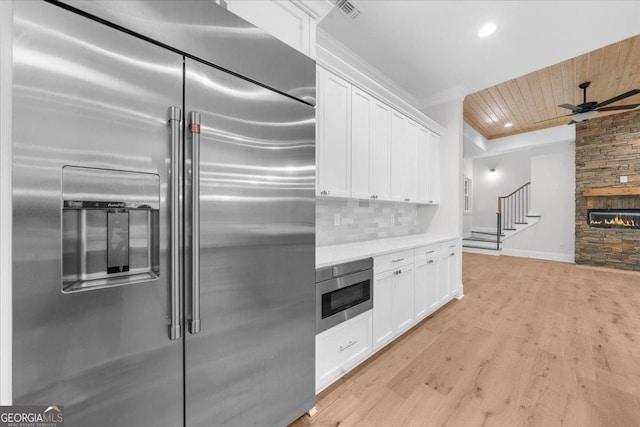 225 Laurel Place Dr, Cornelia, GA 30531 - kitchen with high end refrigerator, white cabinetry, ceiling fan, light wood-type flooring, and wood ceiling