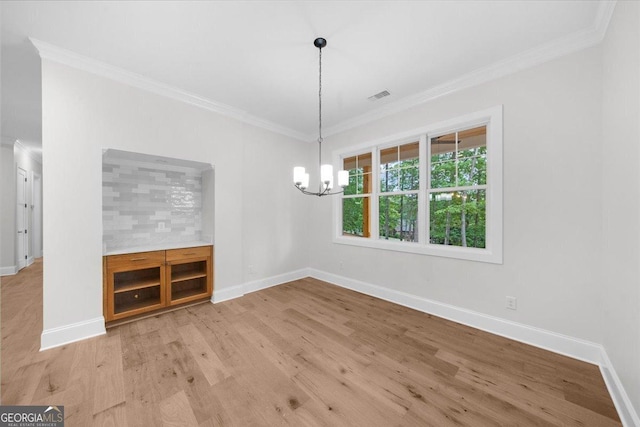 225 Laurel Place Dr, Cornelia, GA 30531 - unfurnished dining area with ornamental molding, baseboards, wood finished floors, and a chandelier