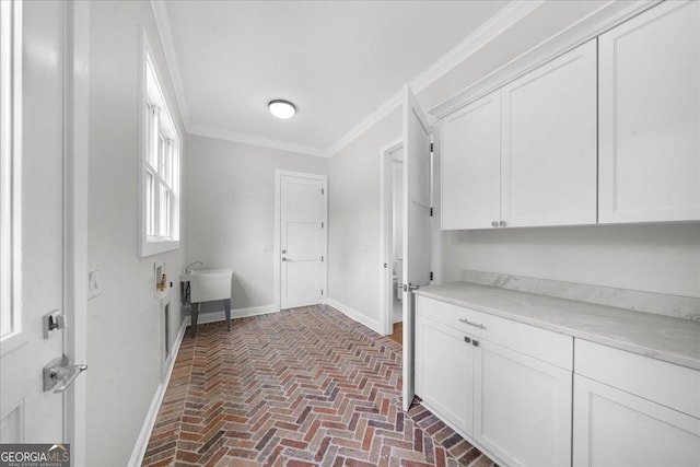 225 Laurel Place Dr, Cornelia, GA 30531 - washroom with brick floors, ornamental molding, baseboards, and cabinet space