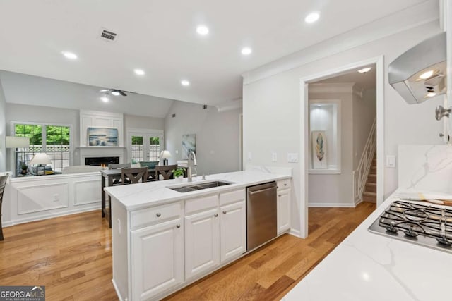 550 Mae Ln, Alpharetta, GA 30004 - kitchen featuring a sink, appliances with stainless steel finishes, wall chimney range hood, white cabinets, and light stone counters