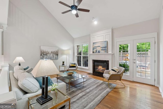 550 Mae Ln, Alpharetta, GA 30004 - living room featuring high vaulted ceiling, a fireplace with flush hearth, wood finished floors, ceiling fan, and french doors