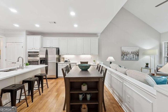 550 Mae Ln, Alpharetta, GA 30004 - dining room featuring light wood-style flooring, recessed lighting, and vaulted ceiling