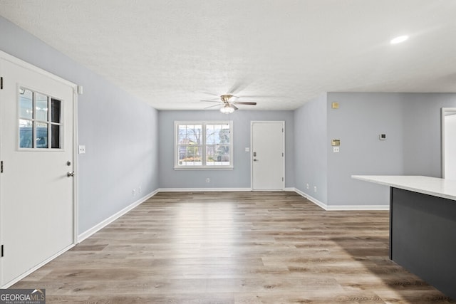 202 E 5th Ave, Winder, GA 30680 - foyer with ceiling fan, a textured ceiling, light wood-style flooring, and baseboards