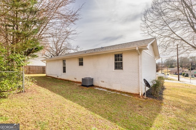 202 E 5th Ave, Winder, GA 30680 - back of property featuring crawl space, brick siding, central AC unit, and roof with shingles