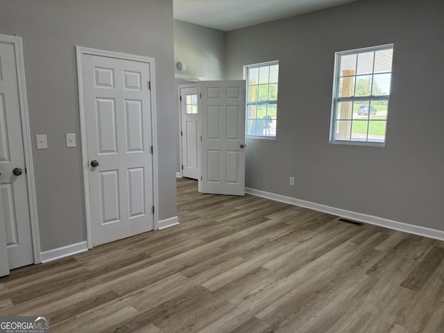1300 Murphy Ave, Lagrange, GA 30240 - unfurnished bedroom with wood finished floors, baseboards, and multiple windows
