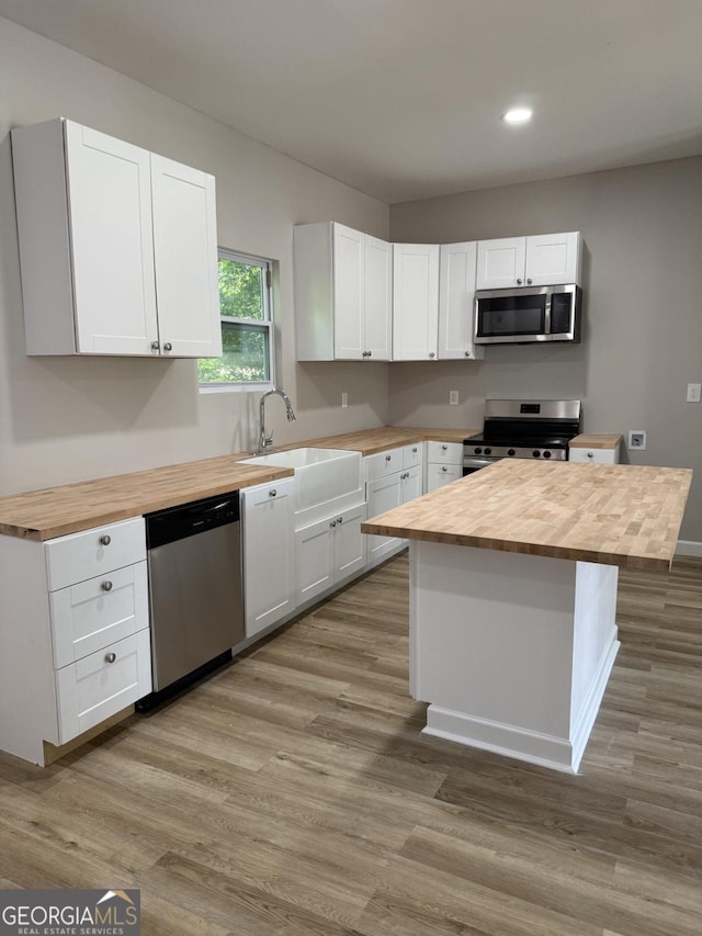 1300 Murphy Ave, Lagrange, GA 30240 - kitchen with butcher block counters, stainless steel appliances, recessed lighting, white cabinets, and wood finished floors