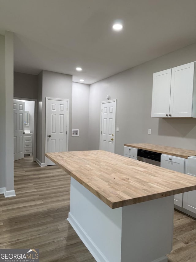 1300 Murphy Ave, Lagrange, GA 30240 - kitchen featuring butcher block countertops, baseboards, dark wood-style floors, white cabinets, and dishwasher