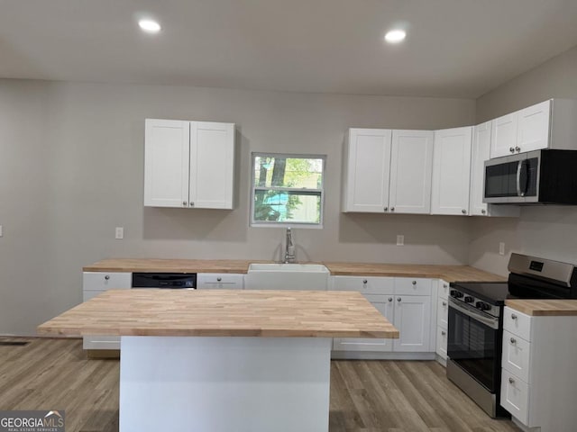1300 Murphy Ave, Lagrange, GA 30240 - kitchen with wood counters, appliances with stainless steel finishes, a sink, light wood-type flooring, and recessed lighting
