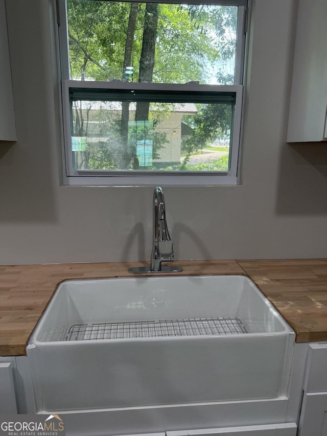 1300 Murphy Ave, Lagrange, GA 30240 - kitchen view of wood counters, a sink, and white cabinetry
