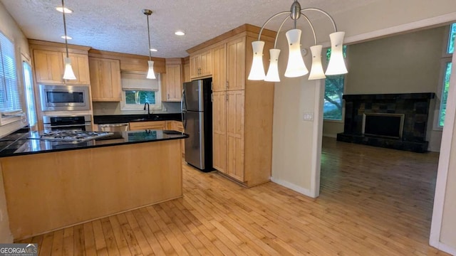 3246 Able Ct, Marietta, GA 30062 - kitchen with stainless steel appliances, recessed lighting, light wood-style flooring, dark countertops, and decorative light fixtures