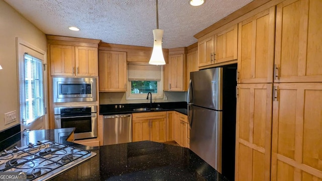 3246 Able Ct, Marietta, GA 30062 - kitchen with appliances with stainless steel finishes, a textured ceiling, recessed lighting, decorative light fixtures, and dark stone counters