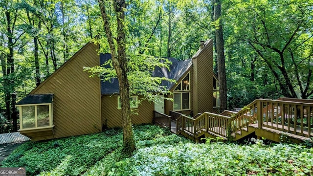 3246 Able Ct, Marietta, GA 30062 - view of property exterior with a wooden deck, roof with shingles, and a chimney