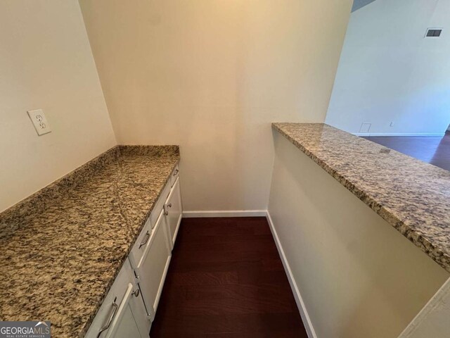 120 Squirrel Way, Atlanta, GA 30349 - kitchen with dark wood-style flooring, white cabinets, and light stone counters