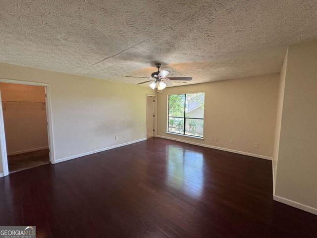 120 Squirrel Way, Atlanta, GA 30349 - empty room featuring dark wood-type flooring, a ceiling fan, and a textured ceiling