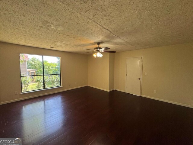120 Squirrel Way, Atlanta, GA 30349 - empty room with ceiling fan, dark wood-type flooring, and a textured ceiling