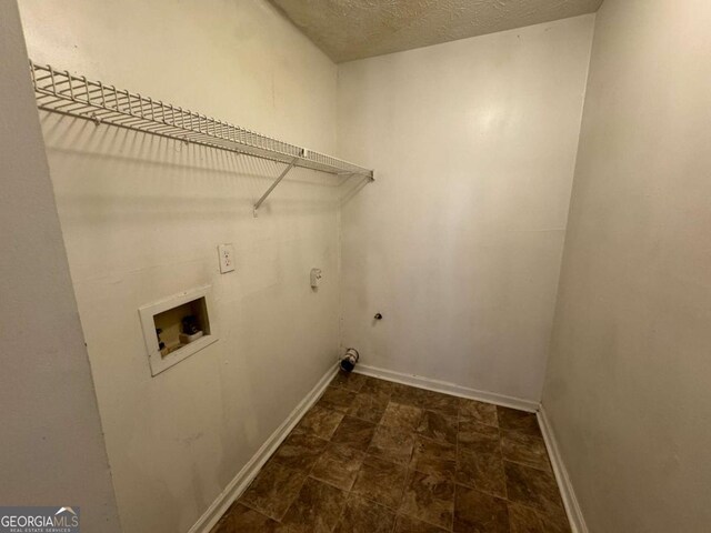 120 Squirrel Way, Atlanta, GA 30349 - washroom featuring electric dryer hookup, hookup for a washing machine, and a textured ceiling