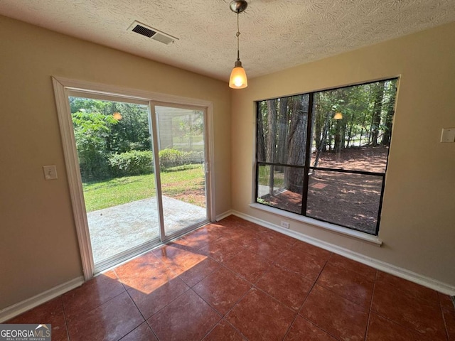 120 Squirrel Way, Atlanta, GA 30349 - unfurnished dining area with tile patterned floors and a textured ceiling