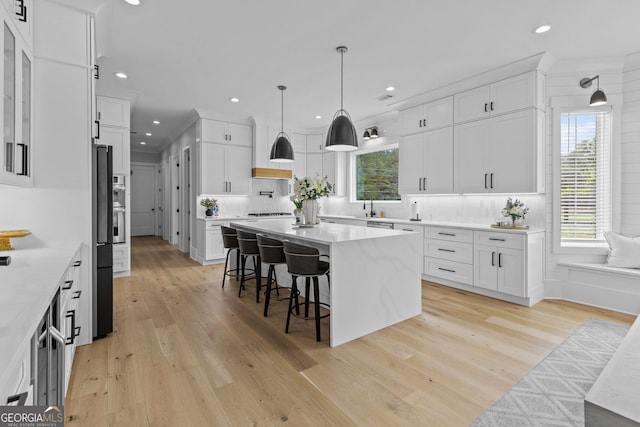 245 Mitchell Rd, Monroe, GA 30656 - kitchen featuring a breakfast bar area, white cabinets, and recessed lighting