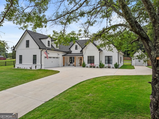 245 Mitchell Rd, Monroe, GA 30656 - modern farmhouse style home with board and batten siding, concrete driveway, a standing seam roof, and roof with shingles
