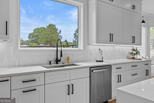 245 Mitchell Rd, Monroe, GA 30656 - kitchen with dishwasher, a sink, healthy amount of natural light, and white cabinetry