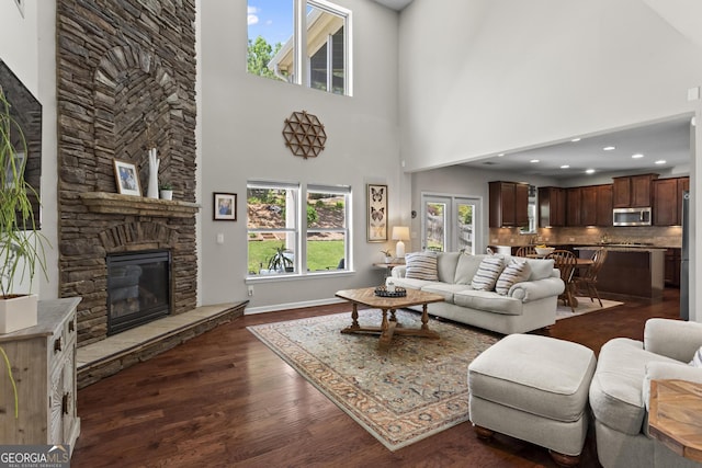 237 Parc Dr, Canton, GA 30114 - living area featuring dark wood-type flooring, a fireplace, and a towering ceiling