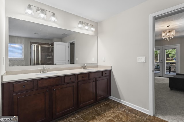 237 Parc Dr, Canton, GA 30114 - bathroom featuring double vanity, a shower stall, tile patterned flooring, french doors, and a chandelier