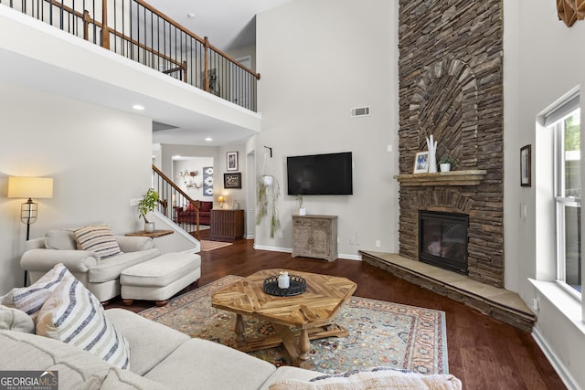 237 Parc Dr, Canton, GA 30114 - living room with a towering ceiling, wood finished floors, a stone fireplace, and stairway