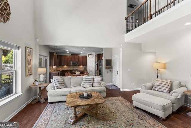 237 Parc Dr, Canton, GA 30114 - living area with a towering ceiling and dark wood-type flooring