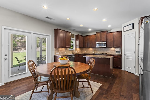 237 Parc Dr, Canton, GA 30114 - kitchen with appliances with stainless steel finishes, dark brown cabinets, backsplash, dark wood-style floors, and recessed lighting
