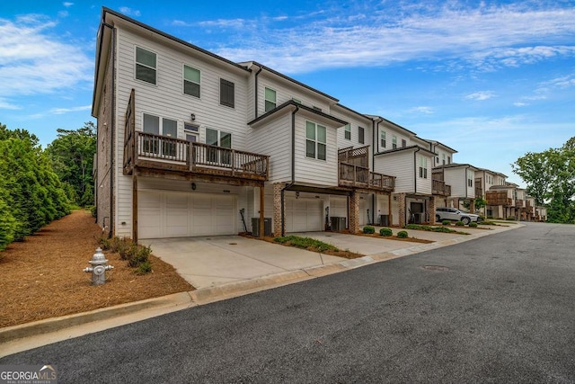 4565 Sims Park Overlook, Suwanee, GA 30024 - view of front of house featuring an attached garage, concrete driveway, brick siding, and a residential view