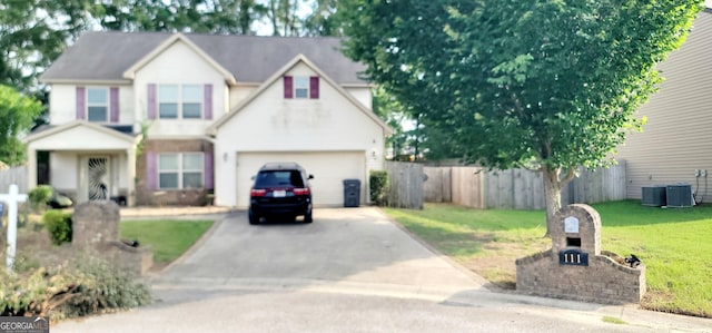 111 Tyndall St, Perry, GA 31069 - traditional-style house with driveway, a garage, and central air condition unit