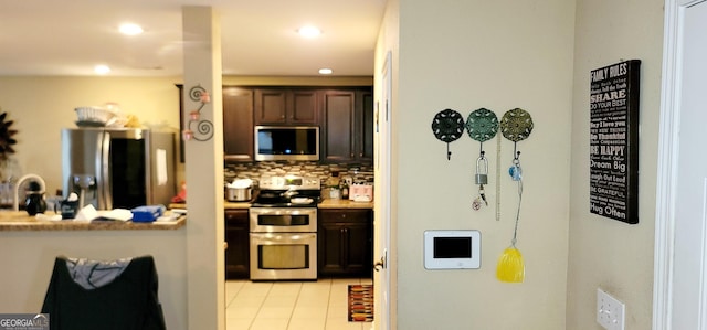 111 Tyndall St, Perry, GA 31069 - kitchen featuring stainless steel appliances, decorative backsplash, light tile patterned floors, recessed lighting, and dark brown cabinetry