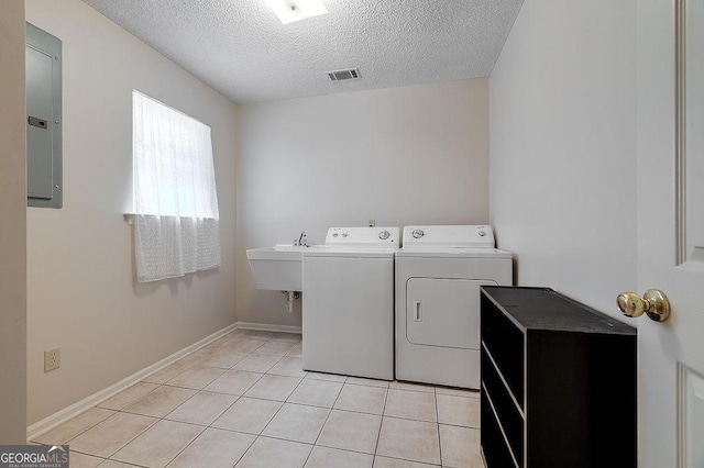 1282 Long Bridge Rd, Rincon, GA 31326 - laundry area featuring washing machine and clothes dryer, electric panel, a textured ceiling, light tile patterned flooring, and baseboards