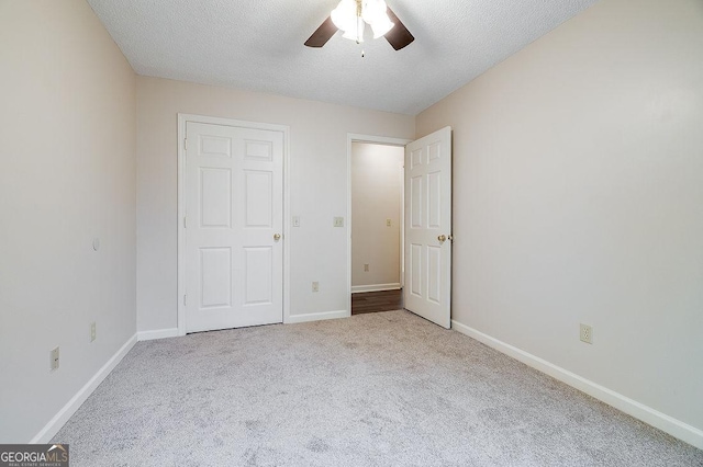 1282 Long Bridge Rd, Rincon, GA 31326 - unfurnished bedroom with carpet flooring, baseboards, a textured ceiling, and a ceiling fan