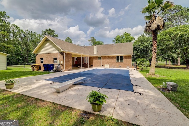 1282 Long Bridge Rd, Rincon, GA 31326 - view of swimming pool featuring a diving board, a patio area, a lawn, and a covered pool