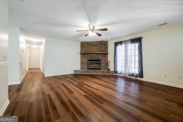 1282 Long Bridge Rd, Rincon, GA 31326 - unfurnished living room featuring a ceiling fan, wood finished floors, a textured ceiling, baseboards, and a fireplace