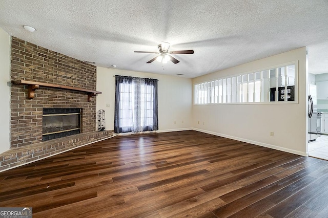 1282 Long Bridge Rd, Rincon, GA 31326 - unfurnished living room featuring a ceiling fan, wood finished floors, a textured ceiling, baseboards, and a fireplace