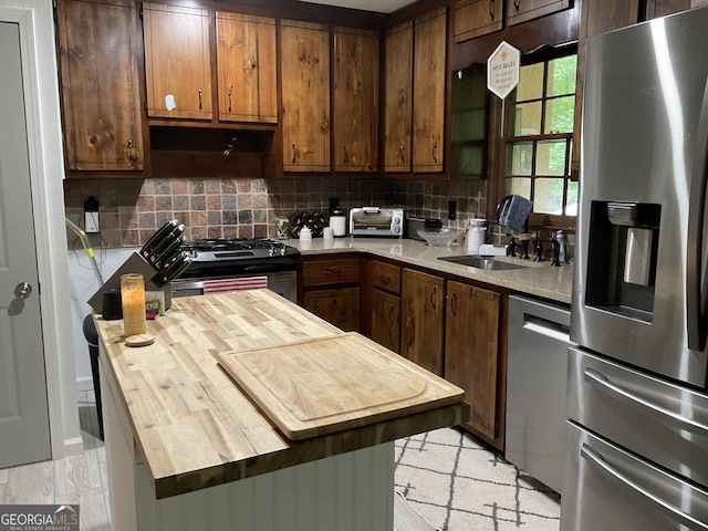 170 Beatrice St, Dallas, GA 30157 - kitchen featuring appliances with stainless steel finishes, butcher block counters, backsplash, a sink, and a kitchen island