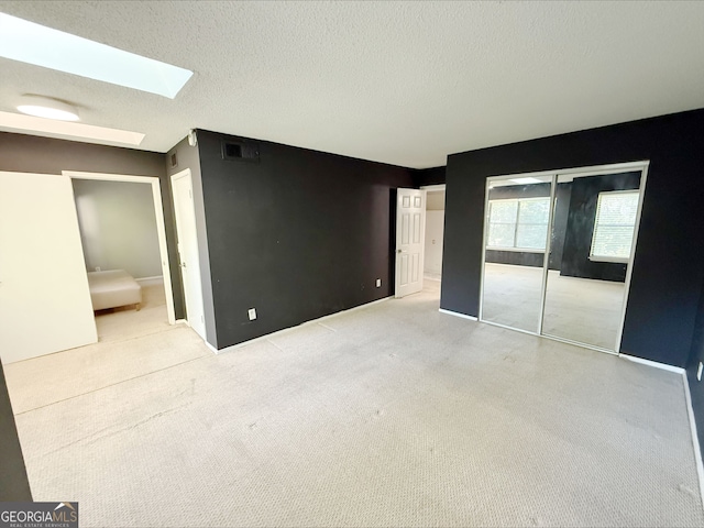 1818 Huntingdon Chase, Atlanta, GA 30350 - carpeted bedroom featuring a skylight and a textured ceiling