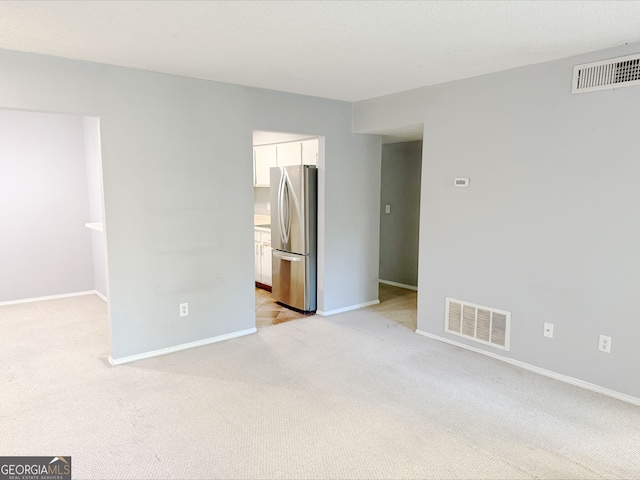 1818 Huntingdon Chase, Atlanta, GA 30350 - unfurnished bedroom with freestanding refrigerator, light colored carpet, and baseboards