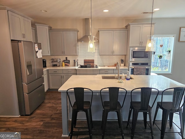 1698 W 5th Hwy, Carrollton, GA 30117 - kitchen with appliances with stainless steel finishes, wall chimney range hood, light countertops, decorative backsplash, and a breakfast bar area