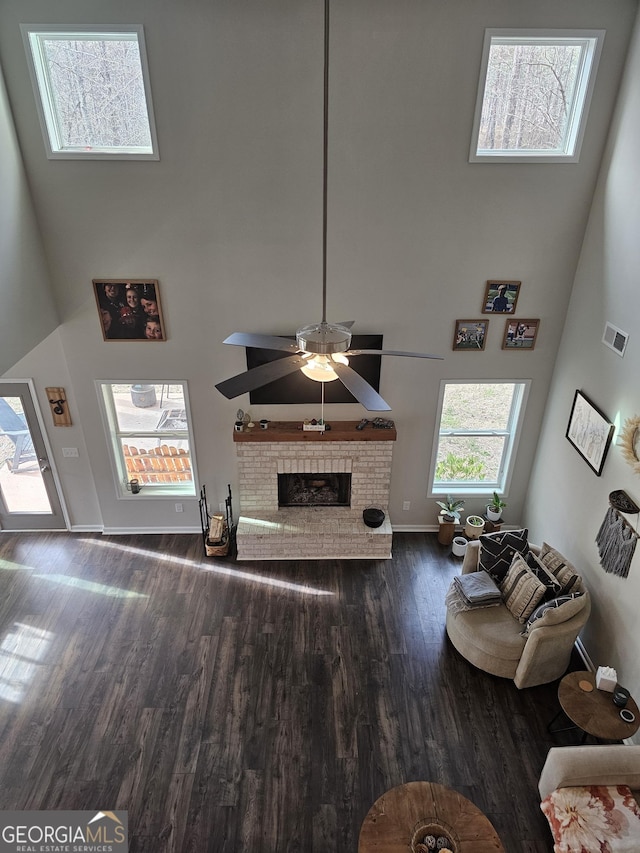 1698 W 5th Hwy, Carrollton, GA 30117 - living room with a high ceiling, wood finished floors, a brick fireplace, baseboards, and a ceiling fan
