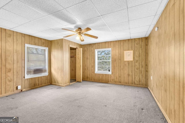 510 Edgewood Ave, Macon, GA 31201 - spare room featuring carpet floors, ceiling fan, wood walls, and a drop ceiling