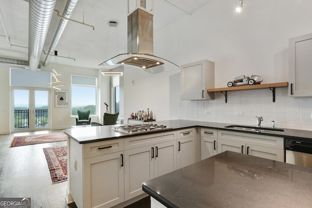 3820 Roswell Rd NE Unit 510, Atlanta, GA 30342 - kitchen featuring island range hood, a sink, stainless steel gas cooktop, and dark countertops