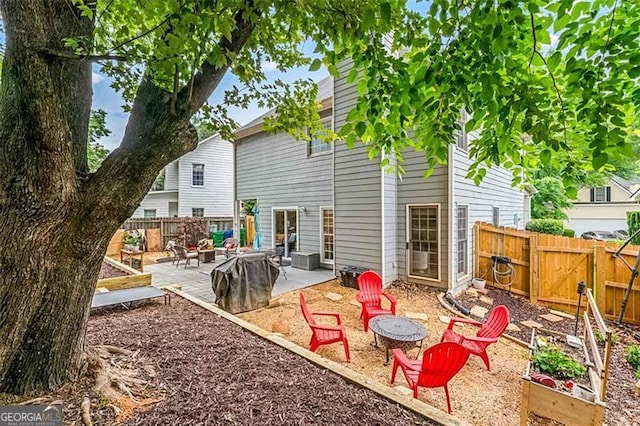 2865 Winter Rose, Dunwoody, GA 30360 - back of property with an outdoor fire pit, a patio, a vegetable garden, and a fenced backyard