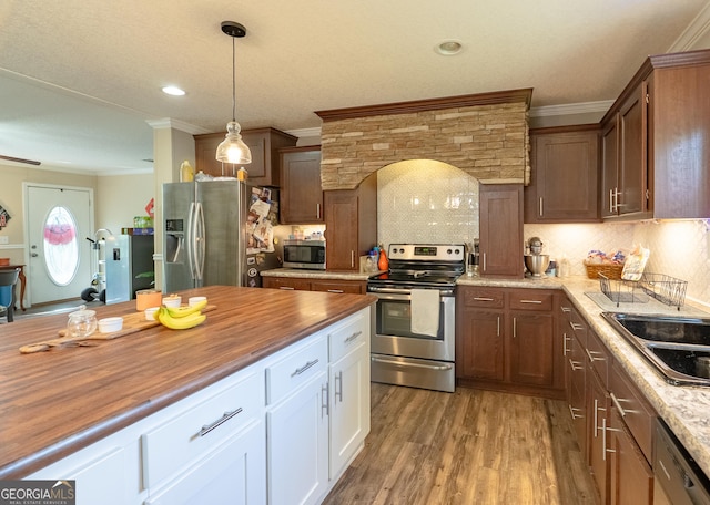 3251 Harrell Rd, Whigham, GA 39897 - kitchen featuring stainless steel appliances, butcher block counters, crown molding, light wood finished floors, and hanging light fixtures